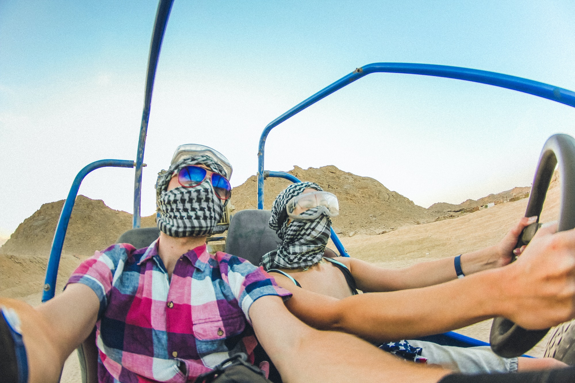 Honeymoon trip to Egypt. A young couple is riding a quad bike in the desert. Excursion in Egypt.